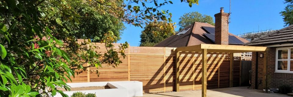 A modern style pergola showcasing Cedar Screening with a rendered raised flower bed